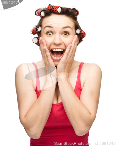 Image of Woman is holding her face in astonishment