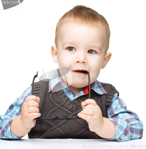 Image of Little child play with book