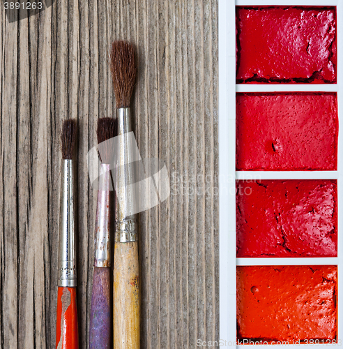 Image of Three brushes for painting and a paint-box