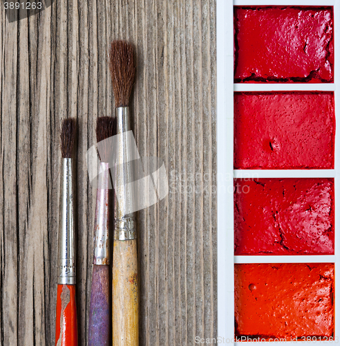 Image of Three brushes for painting and a paint-box