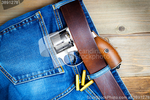 Image of silver revolver nagant in the pocket