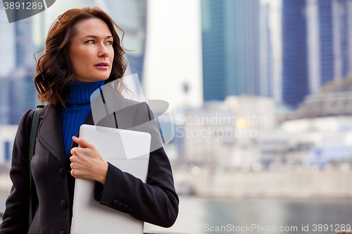 Image of Successful businesswoman with laptop