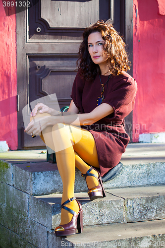 Image of middle-aged woman in a burgundy dress