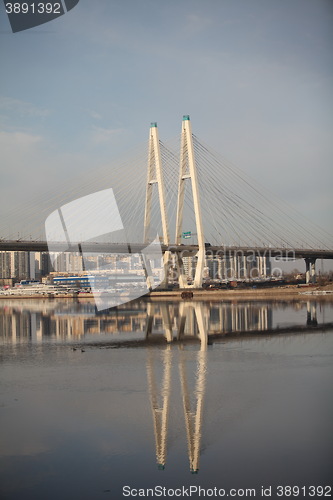 Image of cable-stayed bridge reflected in the river