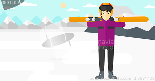 Image of Man holding skis.