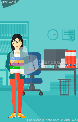 Image of Woman holding pile of folders.