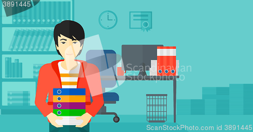 Image of Man holding pile of folders.