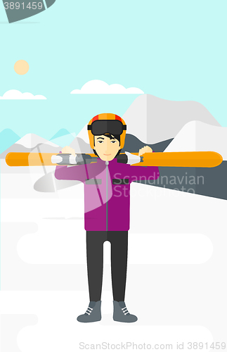 Image of Man holding skis.