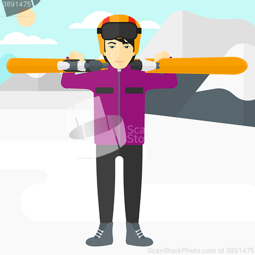 Image of Man holding skis.