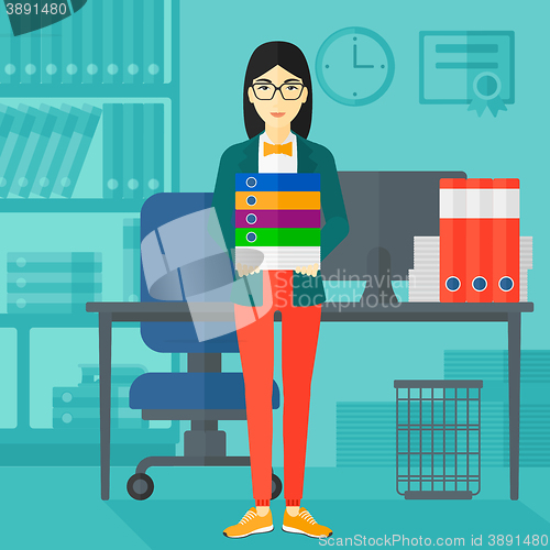 Image of Woman holding pile of folders.