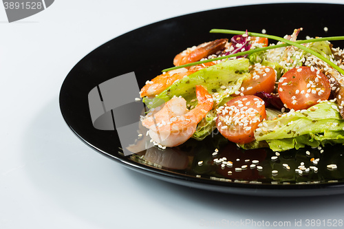 Image of perfect dish with shrimps on a black plate. seafood