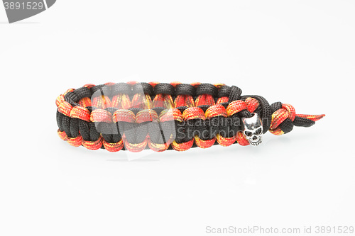 Image of black and orange braided bracelet on white background