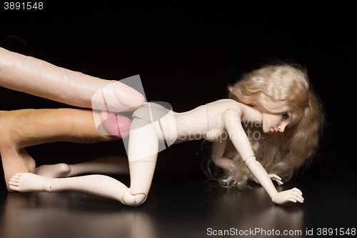 Image of concept. Doll with different sex toys.