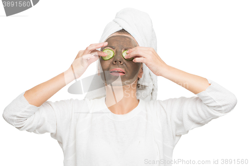 Image of Young beautiful woman in mask for the face. therapeutic black clay. Spa treatment.