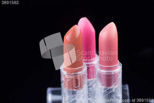 Image of bright lipsticks on a black background