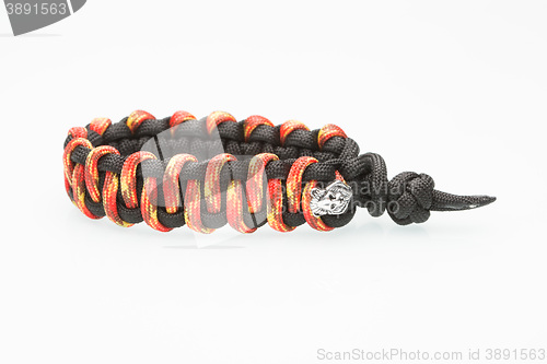 Image of black and orange braided bracelet on white background