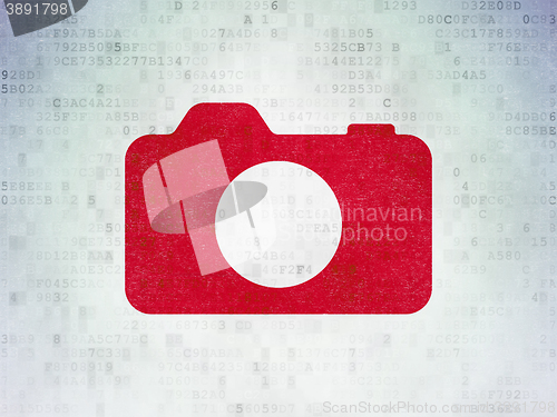 Image of Vacation concept: Photo Camera on Digital Data Paper background