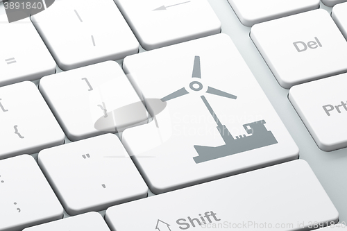 Image of Manufacuring concept: Windmill on computer keyboard background