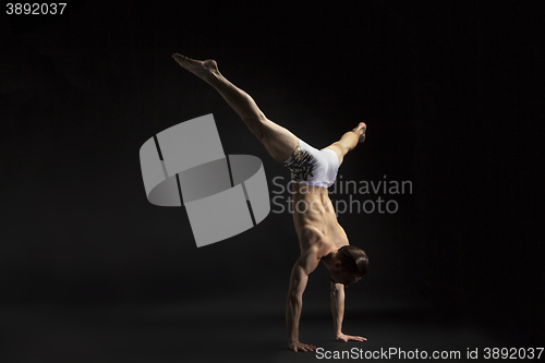 Image of young man dancing over black