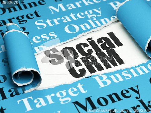 Image of Marketing concept: black text Social CRM under the piece of  torn paper