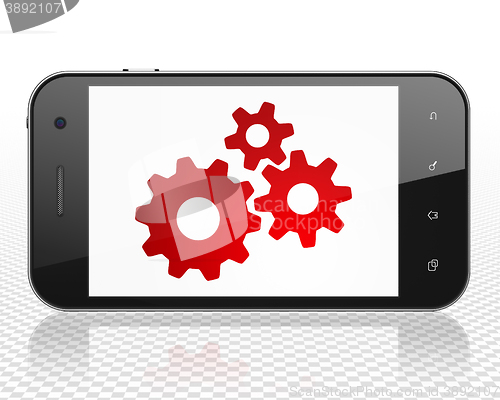 Image of Data concept: Smartphone with Gears on display