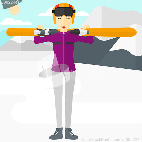 Image of Woman holding skis.