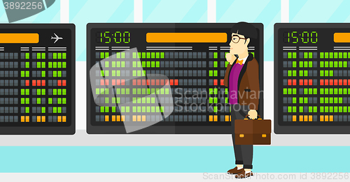 Image of Man looking at schedule board.