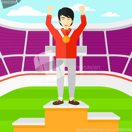 Image of Athlete with medal and hands raised.