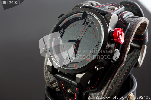 Image of close-up of wristwatch on a black background