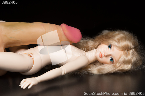 Image of concept. Doll with different sex toys.