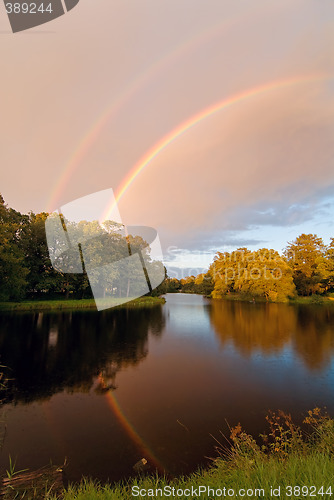 Image of rainbow over autumn pond