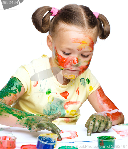 Image of Portrait of a cute girl playing with paints