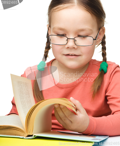 Image of Little girl is reading a book