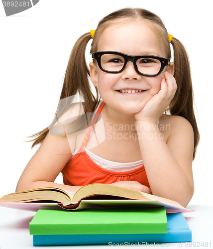 Image of Little girl is reading a book