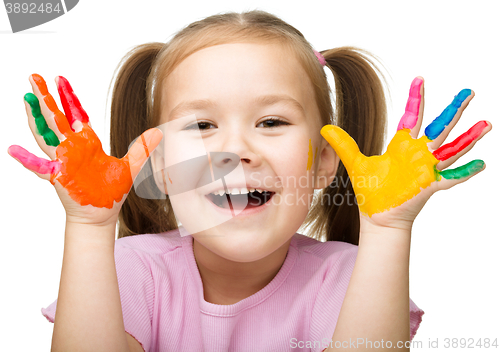Image of Portrait of a cute girl playing with paints