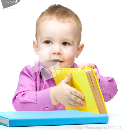 Image of Little child play with book