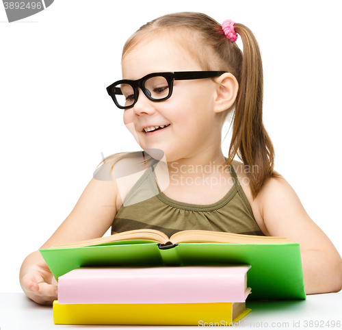 Image of Little girl is reading a book