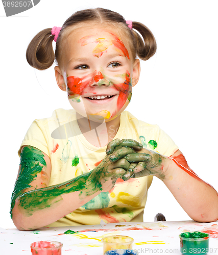 Image of Portrait of a cute girl playing with paints