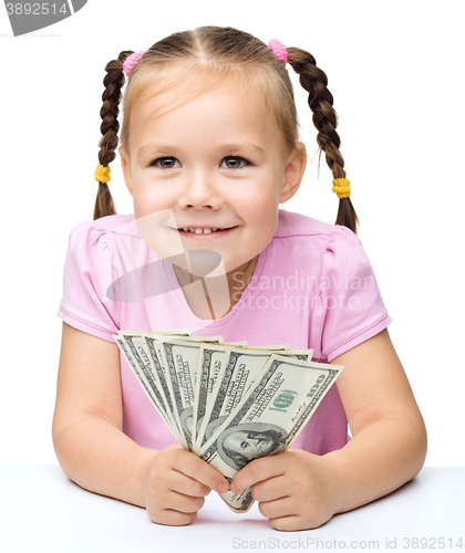 Image of Little girl with dollars