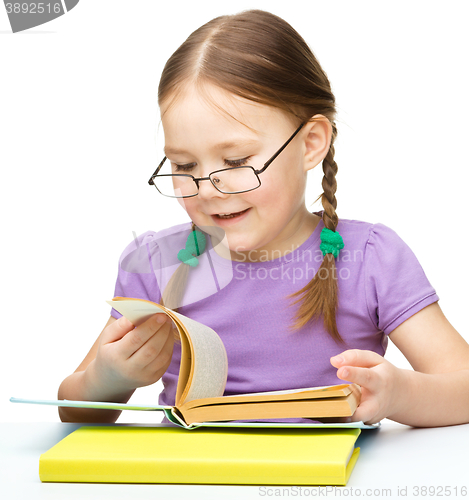 Image of Little girl is reading a book