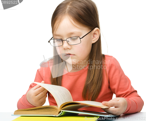 Image of Little girl is reading a book