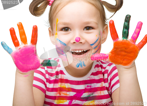 Image of Portrait of a cute girl playing with paints
