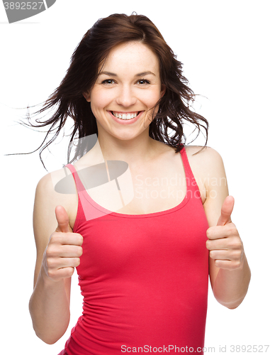 Image of Woman is showing thumb up gesture