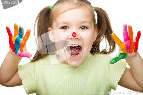 Image of Portrait of a cute girl playing with paints