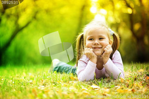 Image of Portrait of a little girl in autumn park