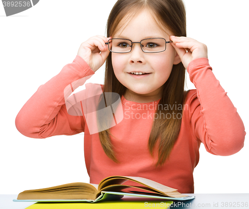 Image of Little girl is reading a book