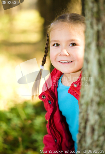 Image of Portrait of a little girl in autumn park