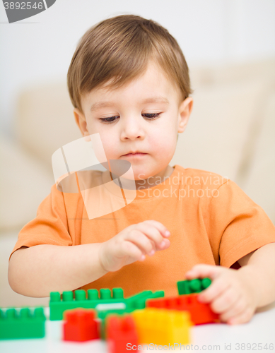 Image of Boy is playing with building blocks