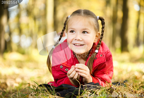 Image of Portrait of a little girl in autumn park