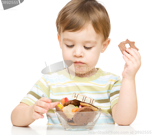 Image of Portrait of a boy with candies